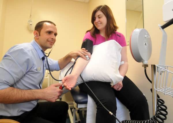 Health reporter Katie Baldwin has her blood pressure checked by Martyn Cutts at Nuffield Leeds Hospital.