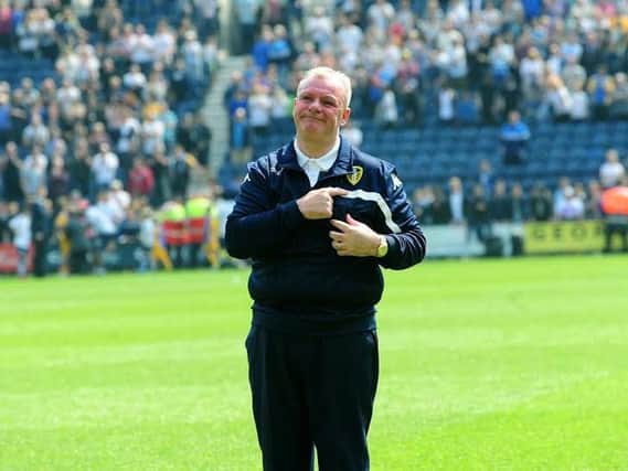 Steve Evans salutes Leeds United's away crowd at Preston.