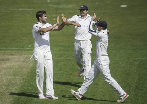 Yorkshire's Liam Plunkett is congratulated by Jack Brooks & Gary Ballance on dismissing Surrey's Rory Burns. Picture: Allan McKenzie/SWpix.com