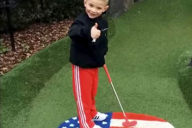 This is the heart-warming moment a four-year-old boy showed up his golf pro dad at The Belfry - by sinking a HOLE-IN-ONE.  See NTI story NTIGOLF.  Pint-sized Owen Wain landed the audacious putt on the 6th hole of the Ryder Legends mini-golf course at The Belfry as dad Neil, 26, captured the proud moment on film.  Onlookers gathered to watch Owen as he sank the 30ft putt at the Ryder Cup venue in Sutton Coldfield, West Mids., on Sunday (8/5).  Footage shows Owen steer the ball up a steep hill which negotiates a tight bend before rolling effortlessly in the hole.  Stunned Neil - who competes full-time at The Belfry - says: "Get in. Yes, well done", before bursting out laughing.  Smiling Owen then calmly turns to his dad and gives him the thumbs up.