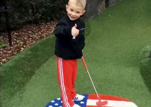 This is the heart-warming moment a four-year-old boy showed up his golf pro dad at The Belfry - by sinking a HOLE-IN-ONE.  See NTI story NTIGOLF.  Pint-sized Owen Wain landed the audacious putt on the 6th hole of the Ryder Legends mini-golf course at The Belfry as dad Neil, 26, captured the proud moment on film.  Onlookers gathered to watch Owen as he sank the 30ft putt at the Ryder Cup venue in Sutton Coldfield, West Mids., on Sunday (8/5).  Footage shows Owen steer the ball up a steep hill which negotiates a tight bend before rolling effortlessly in the hole.  Stunned Neil - who competes full-time at The Belfry - says: "Get in. Yes, well done", before bursting out laughing.  Smiling Owen then calmly turns to his dad and gives him the thumbs up.
