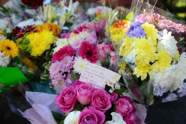 Flowers and cards have been laid outside the house in Gipton.