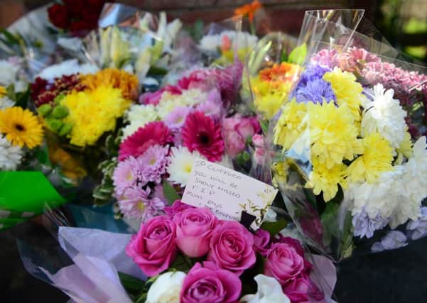 Flowers and cards have been laid outside the house in Gipton.