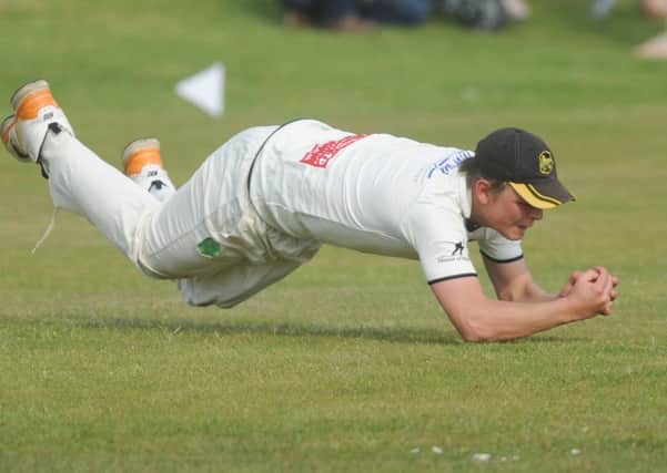 Pudsey St Lawrence bowler Charles Parker at full stretch to catch out Sam Frankland of Woodlands off the bowling of Chris Marsden.