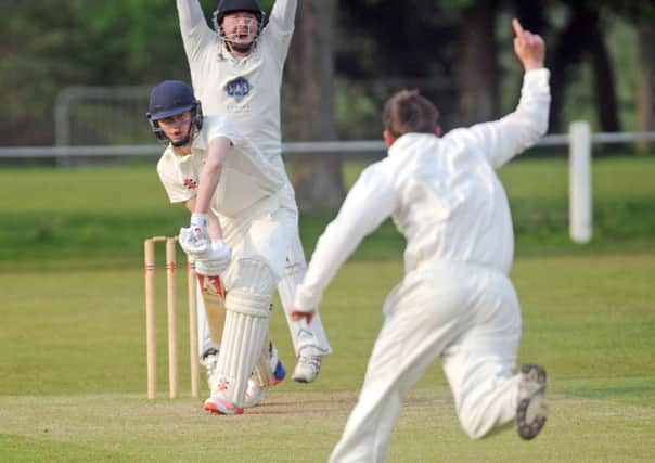 Billy Whitford of Pool is caught by wicket keeper Stephen Peter Wilkinson for 2 runs off the bowling of celebrating Stephen  Brown who took four wickets in the win for Kirkstall.