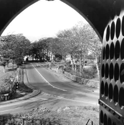 Bramhope, 18th October 1968

The doorway of St. Giles's Church, Bramhope, offers an unusual view of the double bend on the Leeds - Otley Road, familiar to all motorists heading towards Wharfedale.

On the right among the trees can be seen the old Puritan Chapel, which was restored a few years ago.