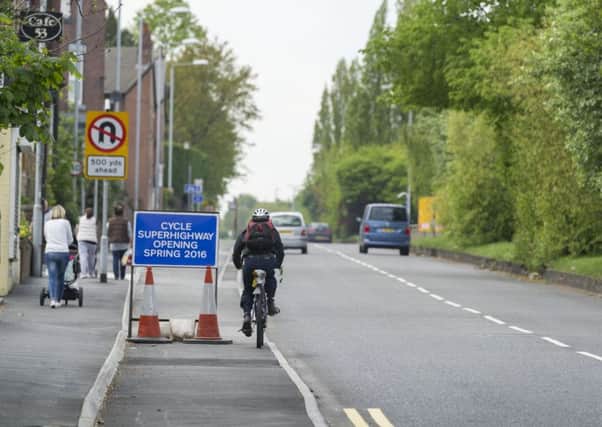 A cyclist riding on the incomplete cycle superhighway on Stanningley Road. Picture by James Hardisty.