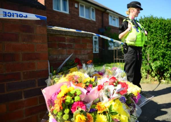 Floral tributes outside the home of Clifford Amoh who was fatally assaulted at his home. Picture Scott Merrylees
