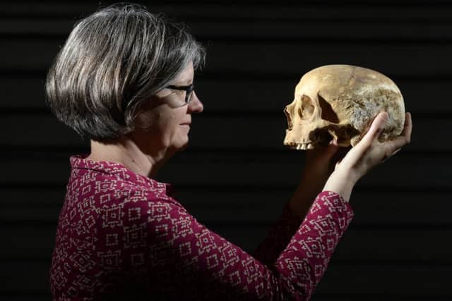 Dr Jane Richardson with a skull found during the dig in Leeds at the site of the Victoria Gate development.
Picture: Bruce Rollinson