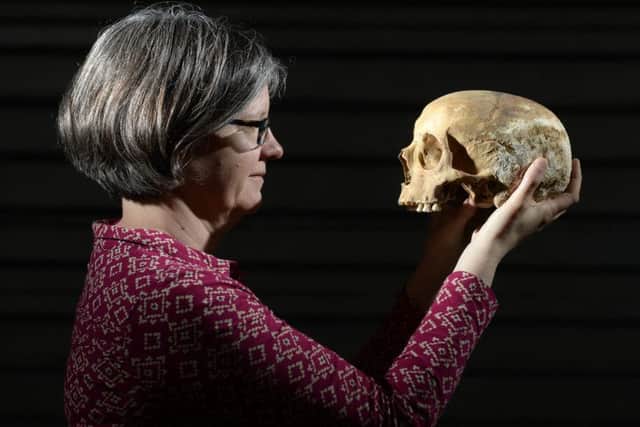 Dr Jane Richardson with a skull found during the dig in Leeds at the site of the Victoria Gate development. PIC: Bruce Rollinson