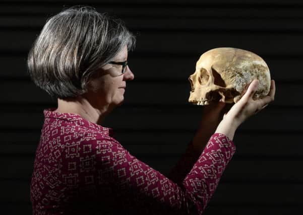Dr Jane Richardson with a skull found during the dig in Leeds at the site of the Victoria Gate development. PIC: Bruce Rollinson