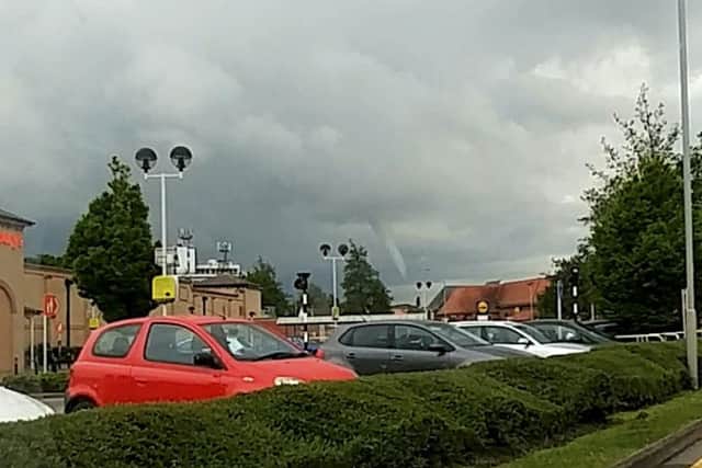 This is the rare moment a mini TWISTER was spotted circling across the skies of a sleepy English town. See NTI story NTITWISTER. The unusual weather phenomenon is more commonly spotted in areas of North America. But shocked locals noticed the strange sight in the market town of Spalding, Lincs., on Wednesday (18/5) night. Eyewitness George Power spotted the funnel cloud with his son Freddie, eleven, as they approached the town from Sutterton, Lincs., along the A16.