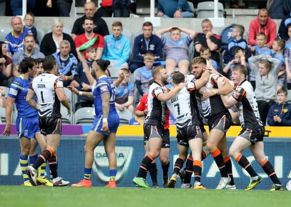Castleford Tigers players celebrate with try scorer Mike McMeeken (second right)  at St James' Park, Newcastle. Picture: Richard Sellers/PA