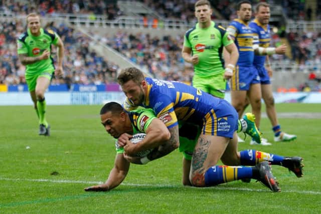 Wigan Warriors' Willie Isa scores a try as Leeds Rhinos' Zak Hardaker challenges. Picture: Richard Sellers/PA