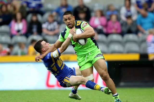 Wigan Warriors' Willie Isa holds off a challenge from Leeds Rhinos' Jordan Lilley. Picture: Richard Sellers/PA.