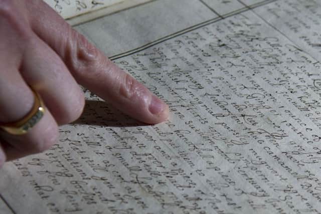 Joanne Fitton, head of special collections, looking at a recipe book from 1683.
