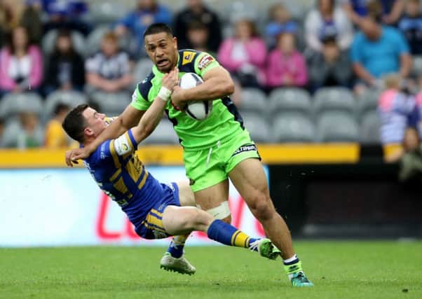 Wigan Warriors' Willie Isa holds off a challenge from Leeds Rhinos' Jordan Lilley during the Dacia Magic Weekend match at St James' Park, Newcastle. (Picture: Richard Sellers/PA Wire).