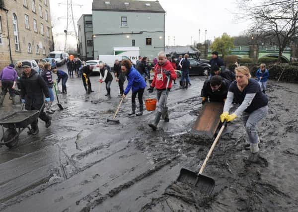 Volunteers clear the mud from the Kirkstall Bridge pub after the flood