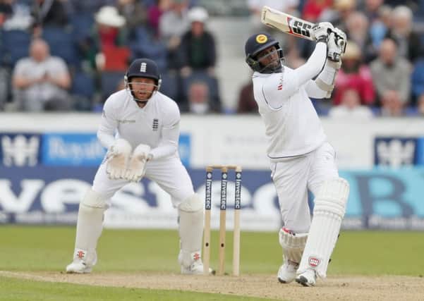 FETCH THAT: Sri Lanka's Angelo Mathews hits a six as Yorkshire's Jonny Bairstow looks on. Picture: Owen Humphreys/PA.