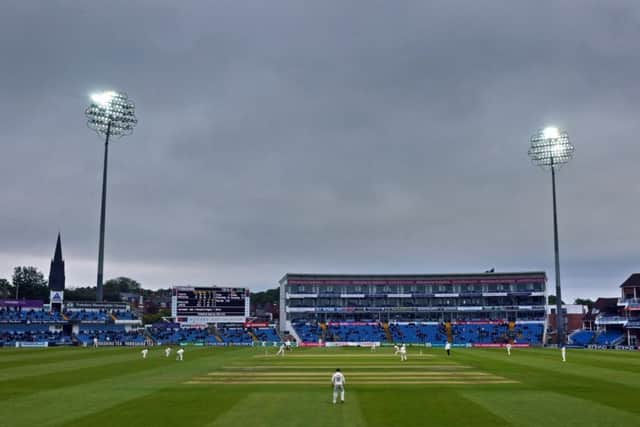 Floodlights pierce the Headingley gloom during day three of Yorkshires Roses clash with Lancashire (Picture: Tony Johnson).