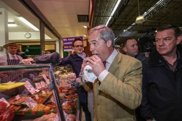UKIP leader Nigel Farage gets a free pork pie on a walk around Leeds Kirkgate market to talk to the public as part of his Leave campaign in the upcoming European referendum.