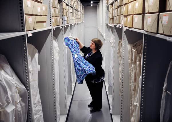 14th March 2012. Archivist Katherine Carter views a 1950's dress, just one of the items from the vast collection held in the new Michael Marks Building at the University of Leeds, which will house M&S full Company Archive collection of more than 70,000 items.