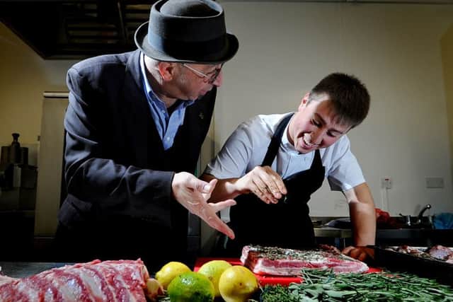 Date:19th November 2015. Picture James Hardisty. 
YEP Photo Essay.......Salvo's Restaurant & Salumeria, Otley Rd, Leeds. Pictured Young chef Salvo Dammone, preparing some Belly Pork, watched by his father Gip Dammone.