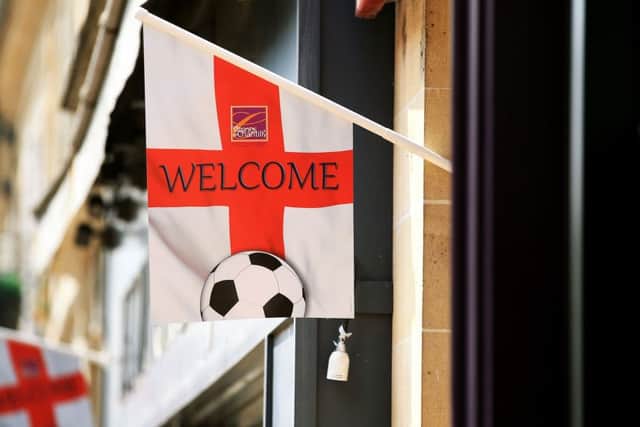 A St George's cross flag with 'Welcome' in Chantilly. PIC: PA