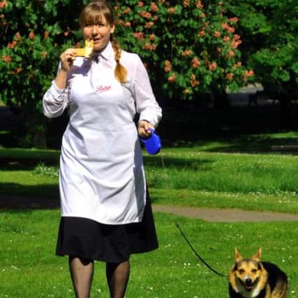 070616   Emma Bulmer from  Bettys and Taylors  sampling a Corgi biscuits they have made to celebrate the Queens 90th birthday whilst walking  Buddy the  Corgi  who modelled for the Corgi biscuits. (GL1010/33e)