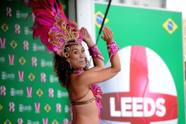 England football fans watch the World Cup match against Uruguay in Millennium Square, Leeds. samba dancers entertain the crowds.
19th June 2014. Picture Jonathan Gawthorpe.