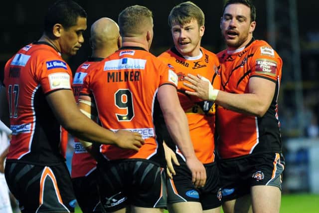 Paddy Flynn is congratulated by team-mates after scoring against Widnes.