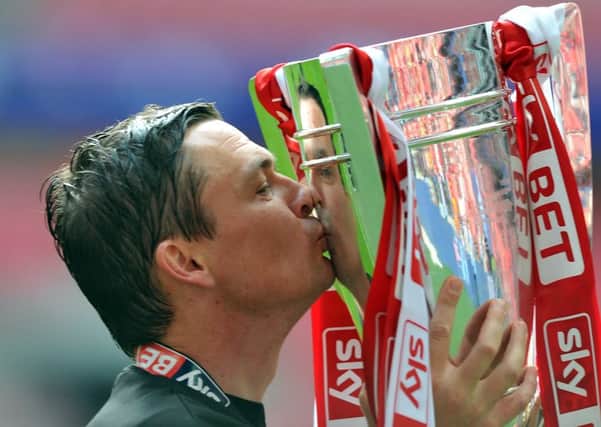 Tykes manager Paul Heckingbottom with the trophy after guiding his side to promotion.  Picture Tony Johnson
