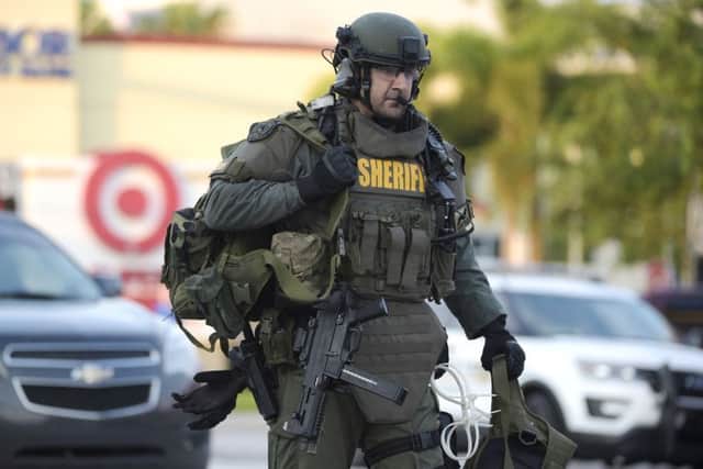 An Orange County Sheriff's Department SWAT member arrives to the scene of a fatal shooting at Pulse Orlando nightclub in Orlando. (AP Photo/Phelan M. Ebenhack)