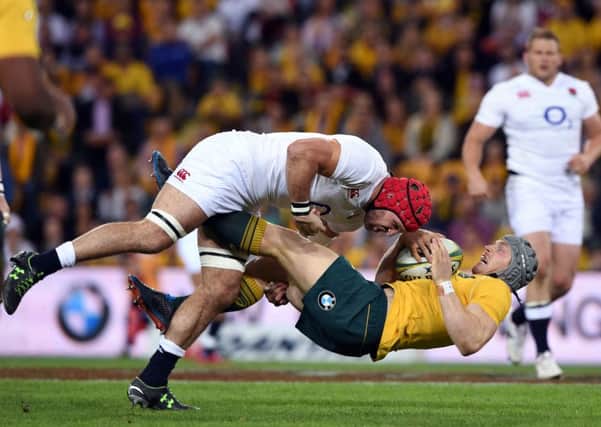 BANG! England's Billy Vunipola, left, tackles Australia's David Pocock in the tourists' victory. Picture: AP.
