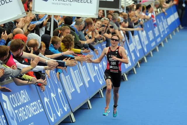 Vicky Holland is greeted by a huge crowd in Leeds' Millenium Square as she runs into third place in the 2016 ITU World Triathlon. Picture: Tony Johnson.