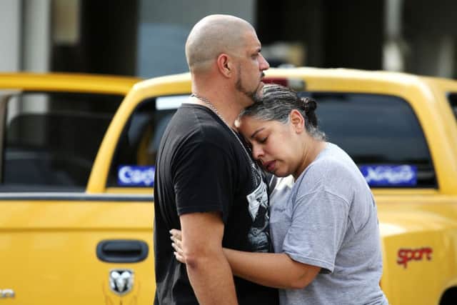 Ray Rivera, a DJ at Pulse Orlando nightclub, is consoled by a friend, outside of the Orlando Police Department after a shooting involving multiple fatalities at the nightclub. (Joe Burbank/Orlando Sentinel via AP)