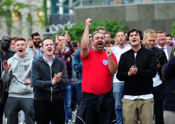 England fans gather to watch the Wales match in Millennium Square, Leeds. Picture by Jonathan Gawthorpe.