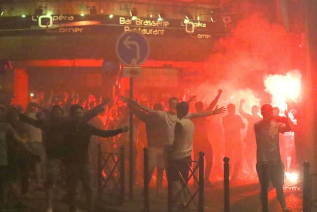 England fans lit by a burning flare in Lille city centre, France, as fresh clashes have taken place between England fans and Russian hooligans at Euro 2016.