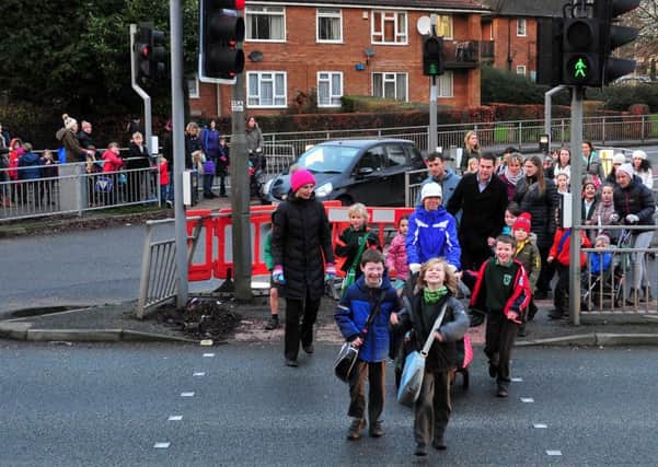Parents and children pictured in January using the pedestrian traffic island in the middle of Leeds Ring Road close to Highfield Primary School