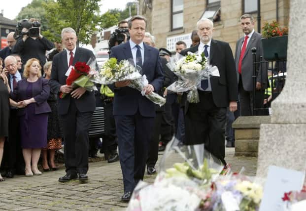 Shadow foreign secretary Hilary Benn, Prime Minister David Cameron and Labour Party leader Jeremy Corbyn lay flowers in Birstall, West Yorkshire, where Labour MP Jo Cox was shot and stabbed to death in the street outside her constituency advice surgery.