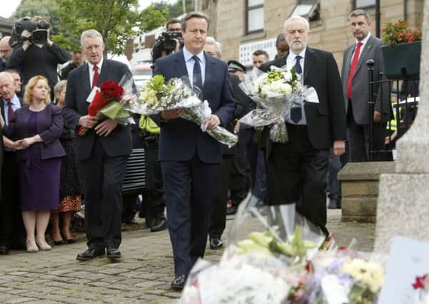 Shadow foreign secretary Hilary Benn, Prime Minister David Cameron and Labour Party leader Jeremy Corbyn lay flowers in Birstall. PIC: PA