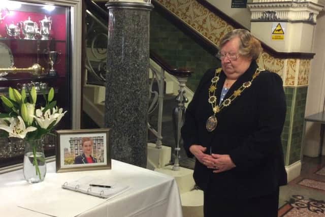Deputy Mayor of Kirklees, Coun Christine Iredale, stands in silence at the opening of a book of condolence for late MP Jo Cox at Batley Town Hall.