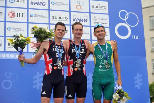 12 June 2016.......       Alistair Brownlee celebrates his win of the 2016 ITU World Triathlon Leeds on the podium in Millenium Square with brother Jonny, left and Australian  Aaron Royle.  Picture Tony Johnson