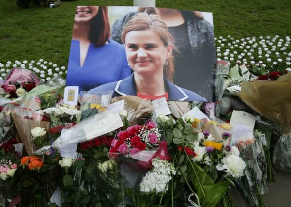 Floral tributes left in Parliament Square, London, after Labour MP Jo Cox was shot and stabbed to death in the street outside her constituency advice surgery in Birstall, West Yorkshire.