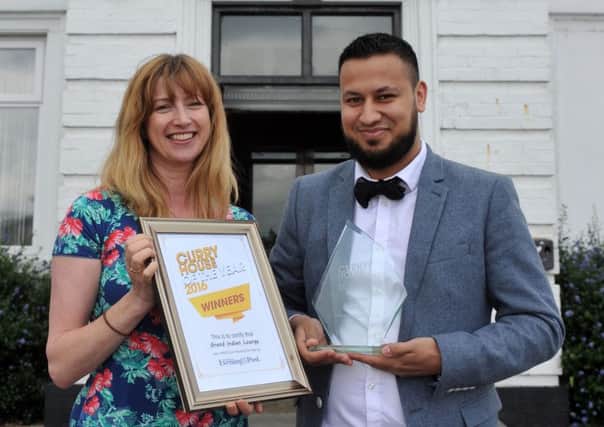 YEP editor Nicola Furbisher  presents the winner of the Curry House of the Year  award to Imran Choudhury at the Grand Indian Lounge on Wakefield Road in Swillington. Picture Tony Johnson