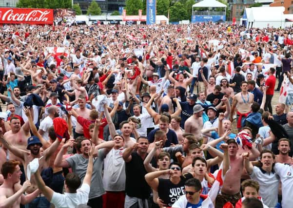 CHEERS: England fans in Lille celebrate as their team score.