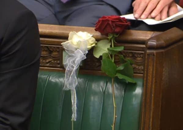 A white and red rose lie on Jo Cox's empty seat in the House of Commons. PIC: PA
