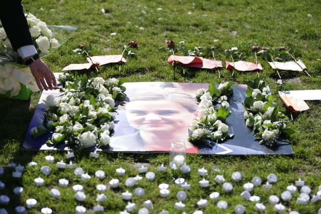 A MP leaves a white rose on a tribute to Labour MP Jo Cox following a service of prayer and remembrance at St Margaret's Church, London.