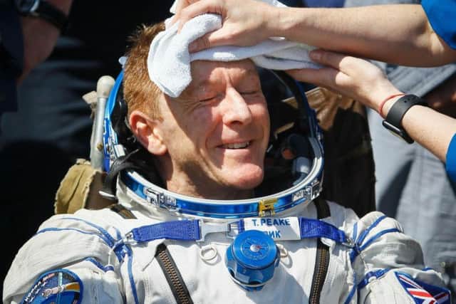 Member of the International Space Station (ISS) crew Britain's Tim Peake is assisted by ground personnel shortly after landing near the town of Dzhezkazgan, Kazakhstan, on Saturday.