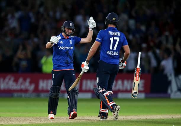 England's Liam Plunkett (right) and Chris Woakes celebrate tying the match off the last ball at Trent Bridge. Picture: Simon Cooper/PA.